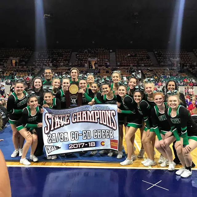 Cheer team holding a banner