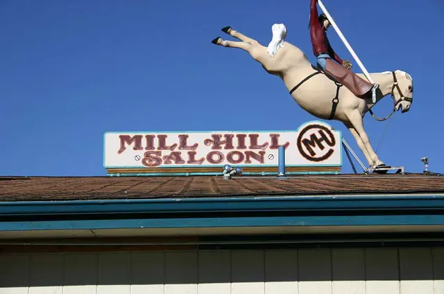 Mill Hill Saloon rooftop sign with bucking-horse rider cutout