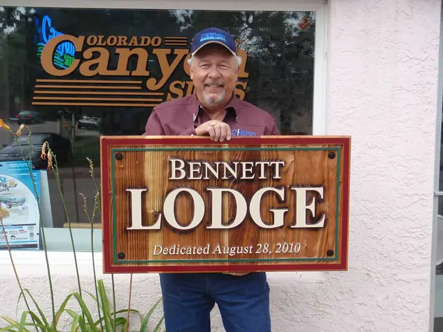 Customer holding a carved Bennett Lodge sign