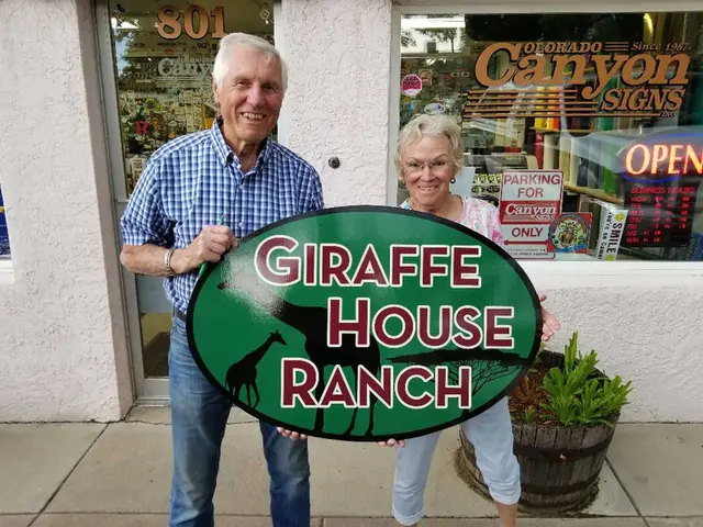 Customers holding a Giraffe House Ranch sign