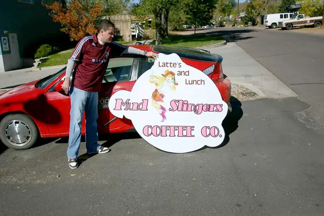 Customer holding a shaped cutout sign