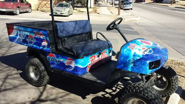 Wrapped golf cart with blue graphics