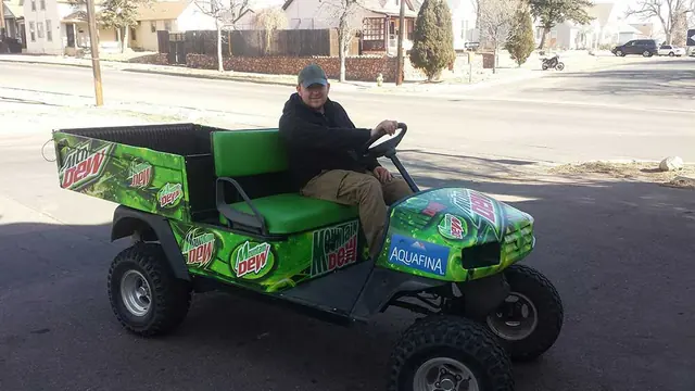 Green wrapped utility cart with driver