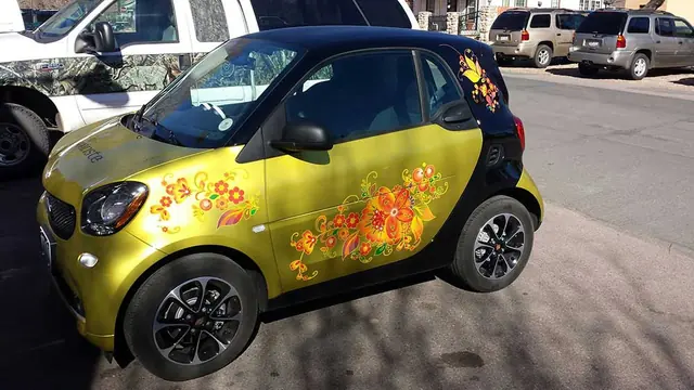Smart car with yellow wrap graphics