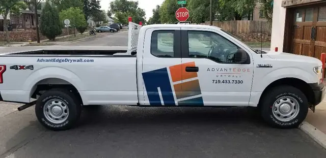 White pickup with logo graphics