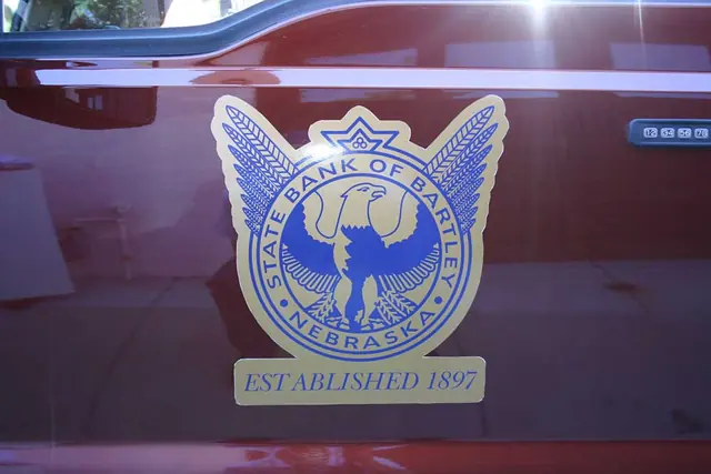 Emblem decal on a red vehicle door