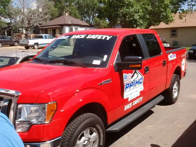 Red pickup with door lettering